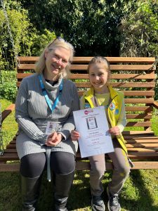 Michelle, Fundraising Manager at the local Mencap office, and Cleo sitting in the Mencap garden at The Hub, Langley Road, Watford